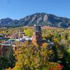 CU Boulder campus in fall colors with flatirons behind