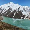 Steep mountains climb out of a glacial lake in the Kangchenjunga region in eastern Nepal 