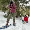 Scott Taylor (center) and two students conduct field research on a snowy day at the Mountain Research Station.