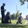 Alli Cook, with campus partners, samples water from a campus storm sewer.