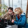 Two students examine grafted apple trees in the CU Boulder Greenhouse.