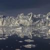 Icebergs, looking like tumbled walls of white, float in the Greenland Sea.