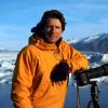 James Balog, founder and director of the Extreme Ice Survey and the Earth Vision Institute, leans on his camera while photographing ice in the field at Jökulsárlón, Iceland. — Credit: Svavar Jónatansson, Extreme Ice Survey