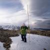 Field Technician Sammy Yevak takes a snow depth reading above the Tundra Lab. Photo by Gabriel De La Rosa.