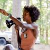Peyton Thomas points and talks to a crowd while holding a megaphone. She is helping kick off the inaugural Equitable Action Run Towards Health (EARTH) event at the Clear Springs Recreation Area in Mississippi’s Homochitto National Forest.