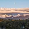 A sweeping view of Niwot Ridge in the Rocky Mountains.  Moon visible above the clouds.