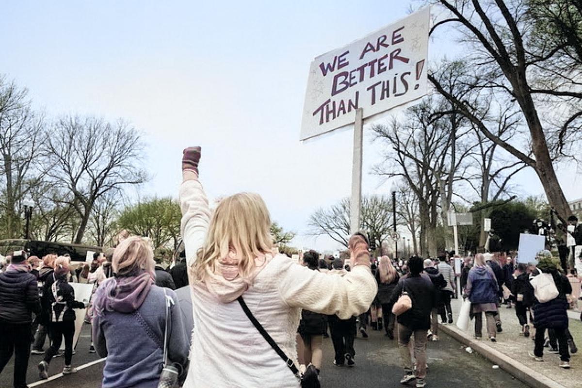 woman with sign at activist rally