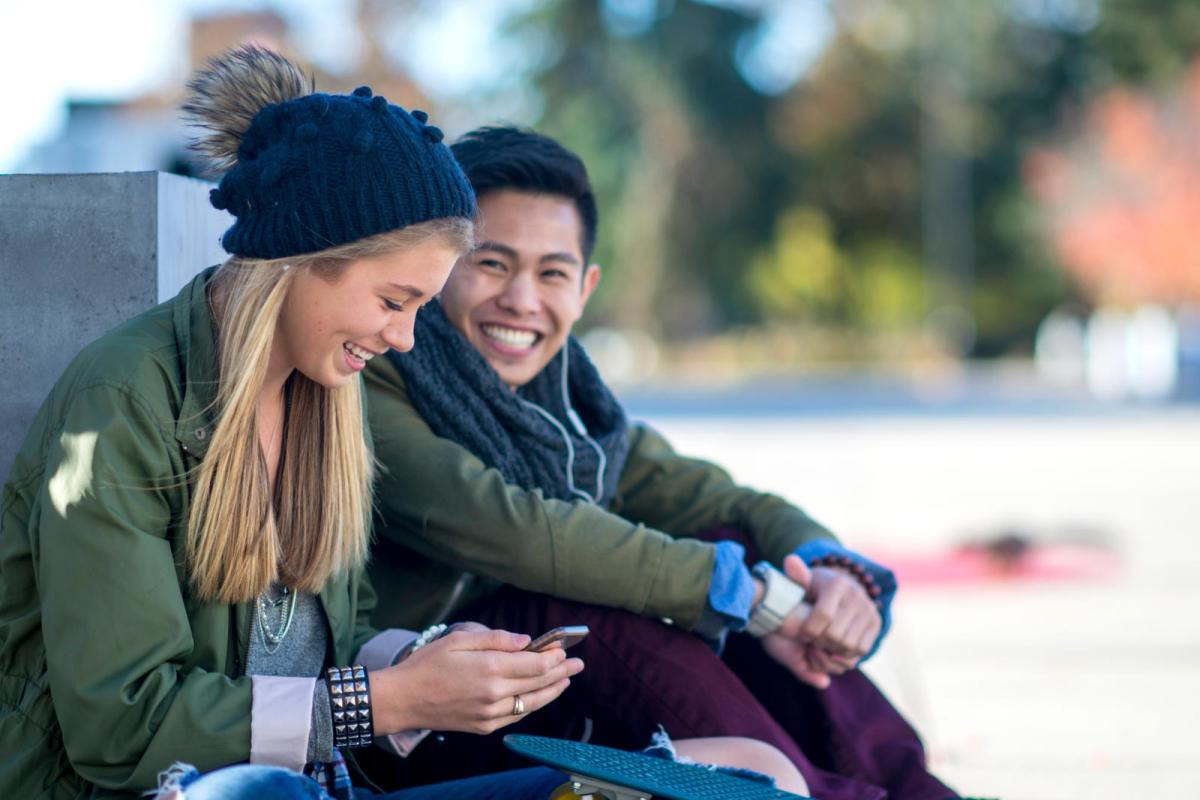 two students looking at a phone