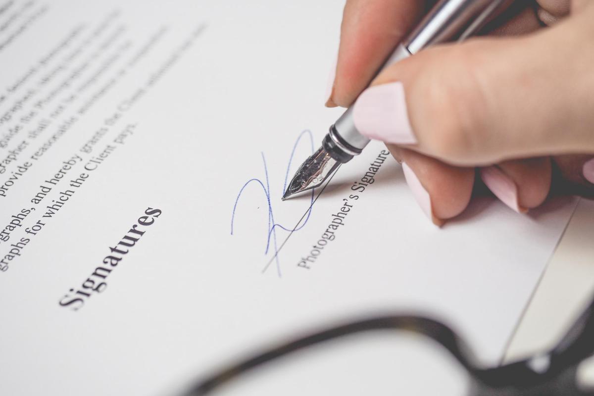 person signing a contract