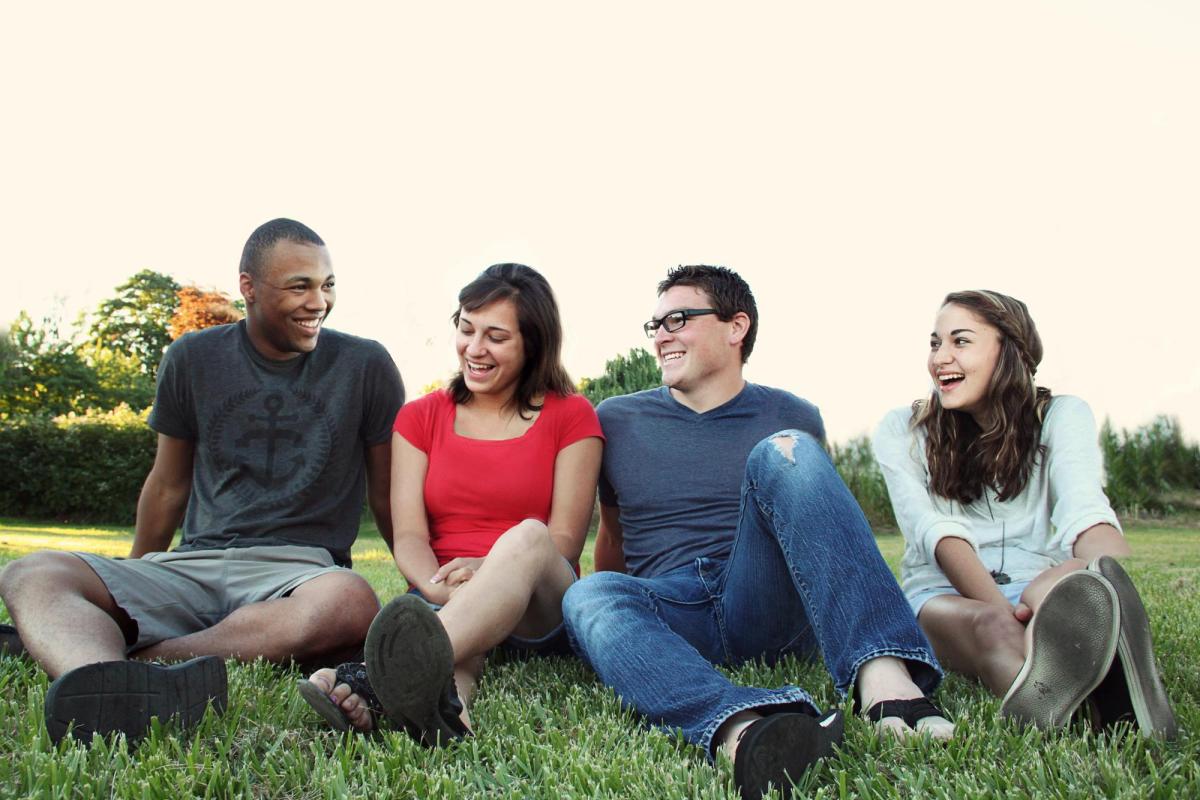 group of people sitting on the grass