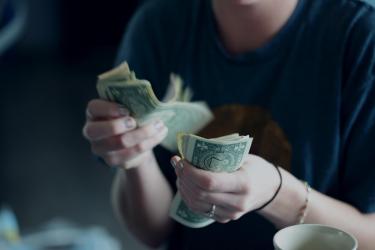 female counting money
