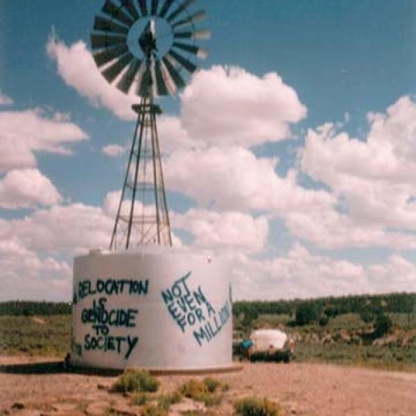 Windmill with political messages spray painted on its side