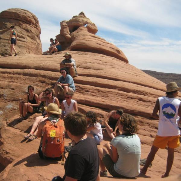 Hikers stop for a break on sandstone rock formations