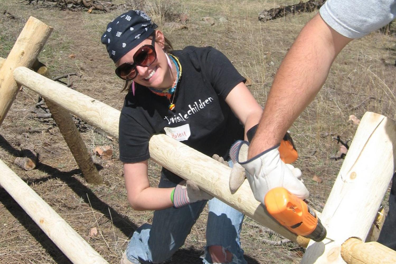 Students helping to build a wooden cattle fence