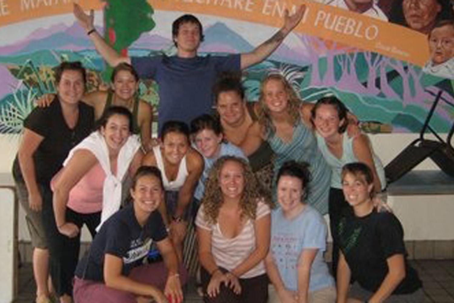 Group of students in front of a mural