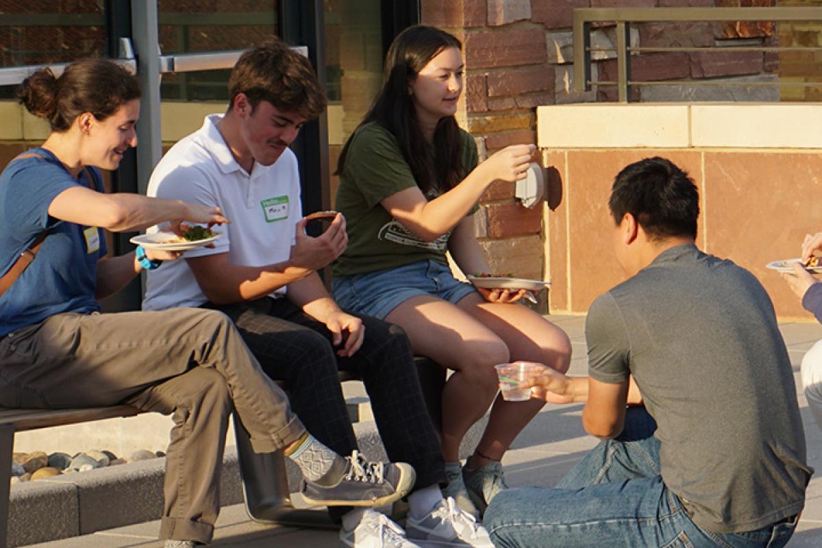 Group of students eating together outdoors
