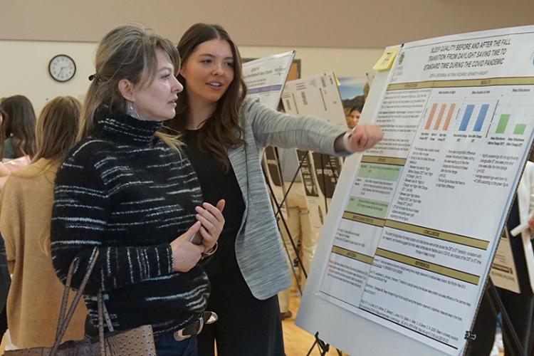 Women at poster presentation