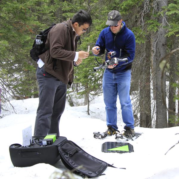 Researches preparing a quadcopter for flight in the forest