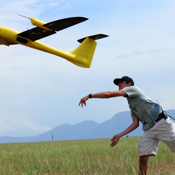 Student launching the Tempest UAS into the air