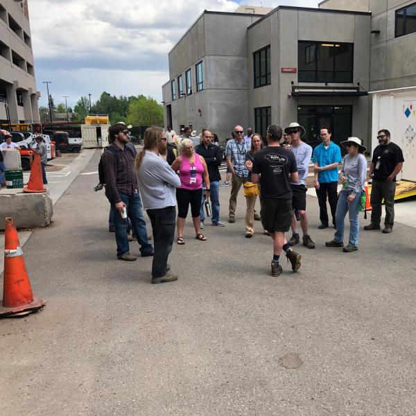 Employees in a circle outside of the GROC beginning a tour
