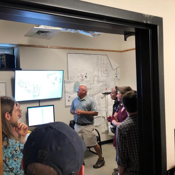 Employees inside the irrigation control room on a tour