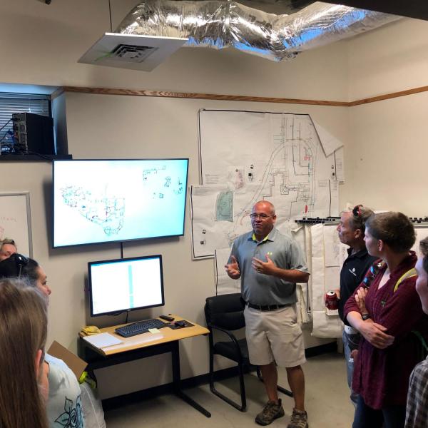 Employees inside the irrigation control room on a tour