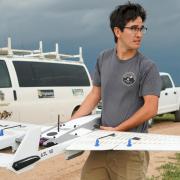 A student getting ready to launch a drone 