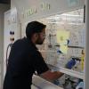 A student working in the lab next to writing on the wall 