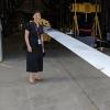 Lucy Pao standing in front of the wind turbine blade 