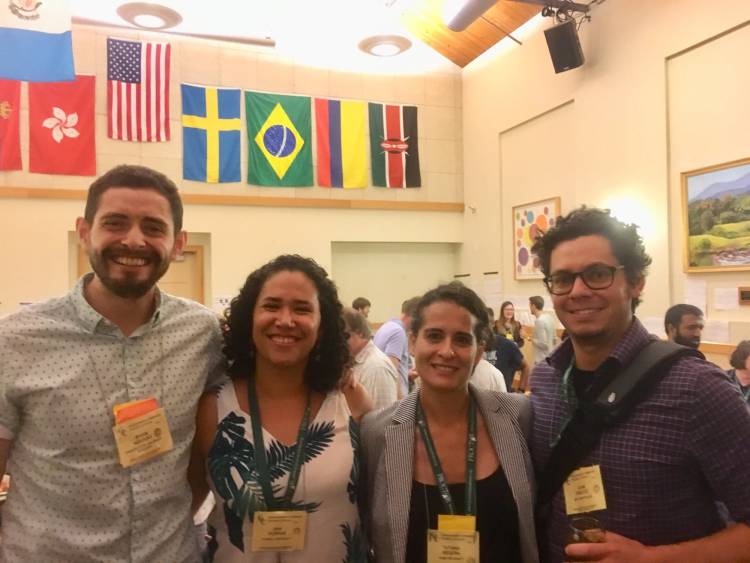 Brian Aguado with friends under flags at a national conference 