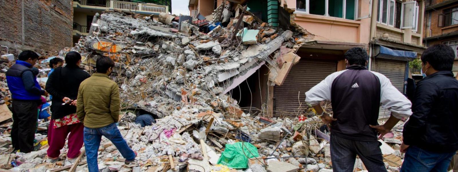 Citizens looking at the destruction from an earthquake