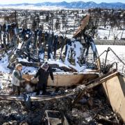 People walking through the disaster area