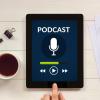 A tablet computer showing a podcast playing