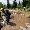 Concrete being poured outside by a team