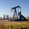 Oil well and storage tanks in a field 