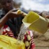 Water being poured into a bucket in Africa.