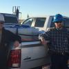 James Rosenblum standing outside next to a truck and co-worker.