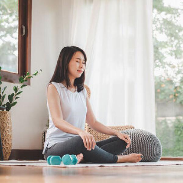 Photo of person sitting cross legged and meditating