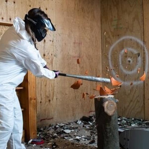Photo of person hitting a pot with a bat