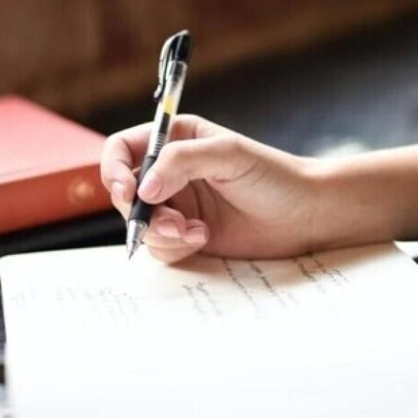 Person writing in notebook