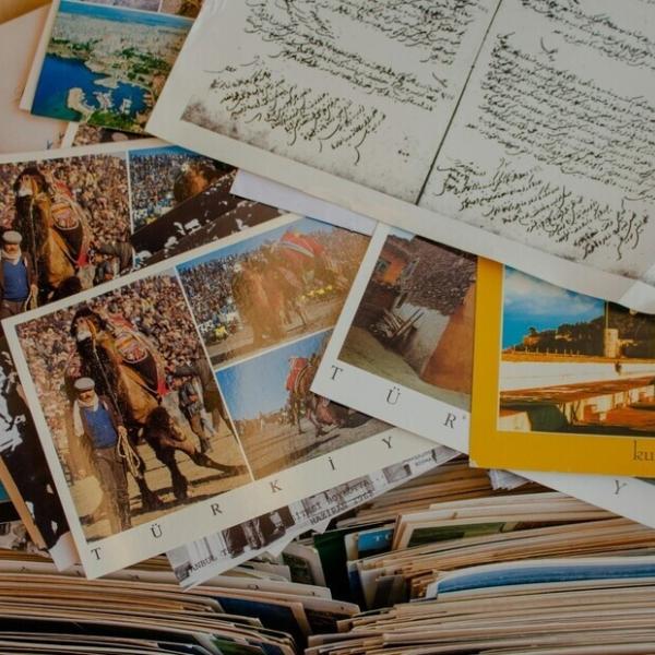 piles of postcards spread out on a table