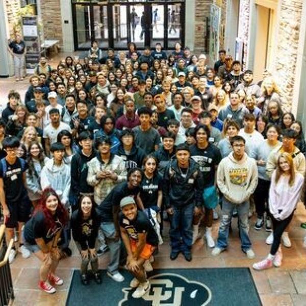 large group of students at base of lobby stairs in UMC