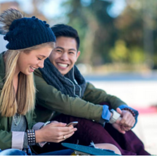 Two Students sitting together outside