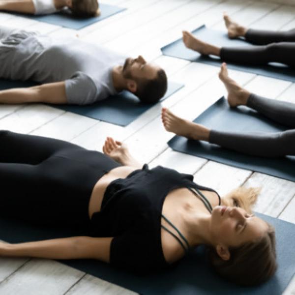 People lying on yoga mats in shivasana pose