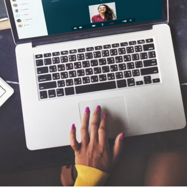 Laptop with hand on mouse pad