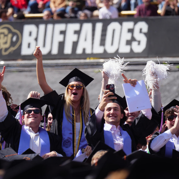 Students celebrating at Commencement ceremony at Folsom Field