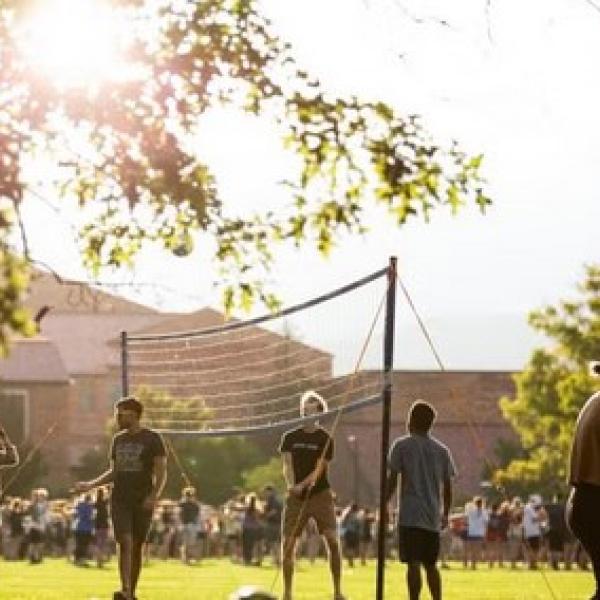 Students playing volleyball on campus
