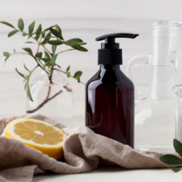 lemon, brown glass soap bottle, jar of sugar