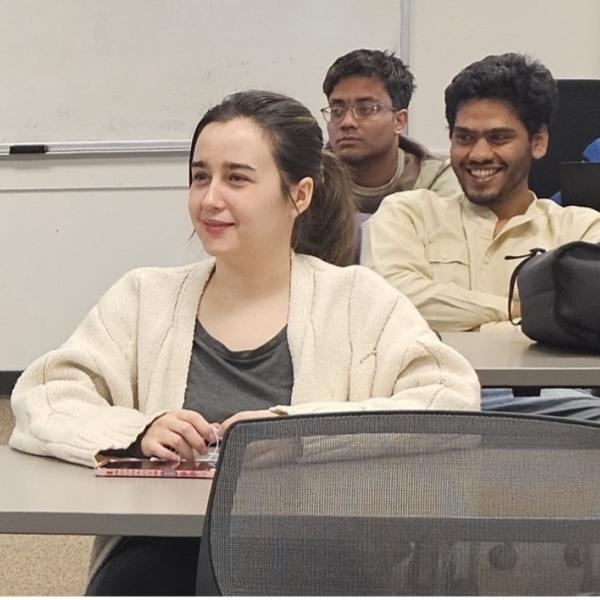 Three sttudents sitting at tables in ESLG classroom