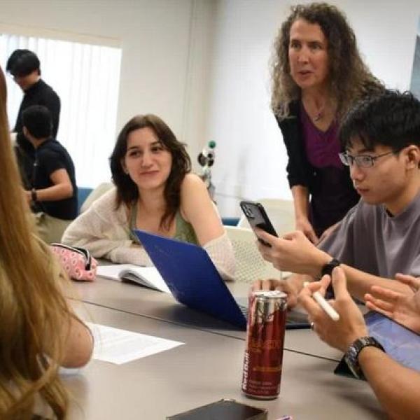 Photo of instructor talking to students